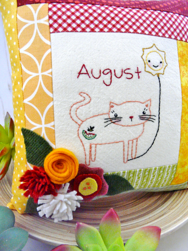 kitty cat holding the month of august hot balloon